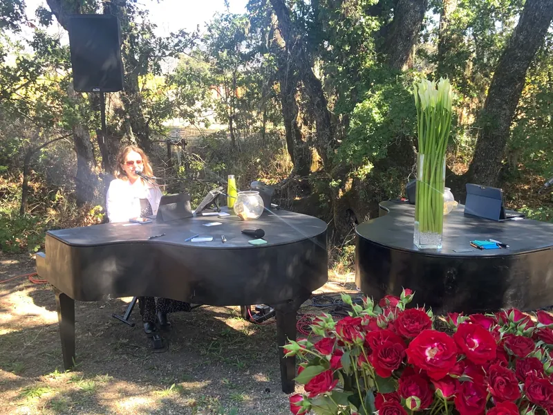 Two piano shells on a garden patio with red flowers