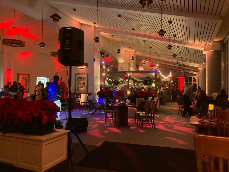 Banquet hall with piano setup, speakers and red uplighting
